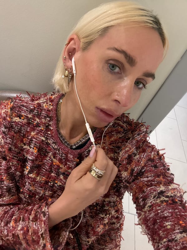 Person with piercings photographed in Dubai wearing tweed outfit