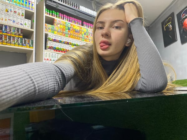 Woman poses for photos inside Russian vape shop