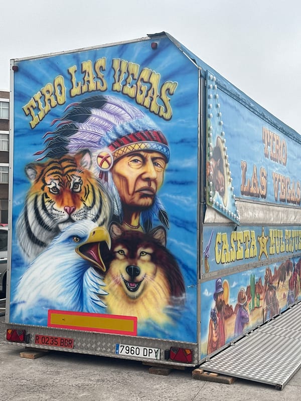 Colorful fairground trailer and waterfront scenes in Gijón