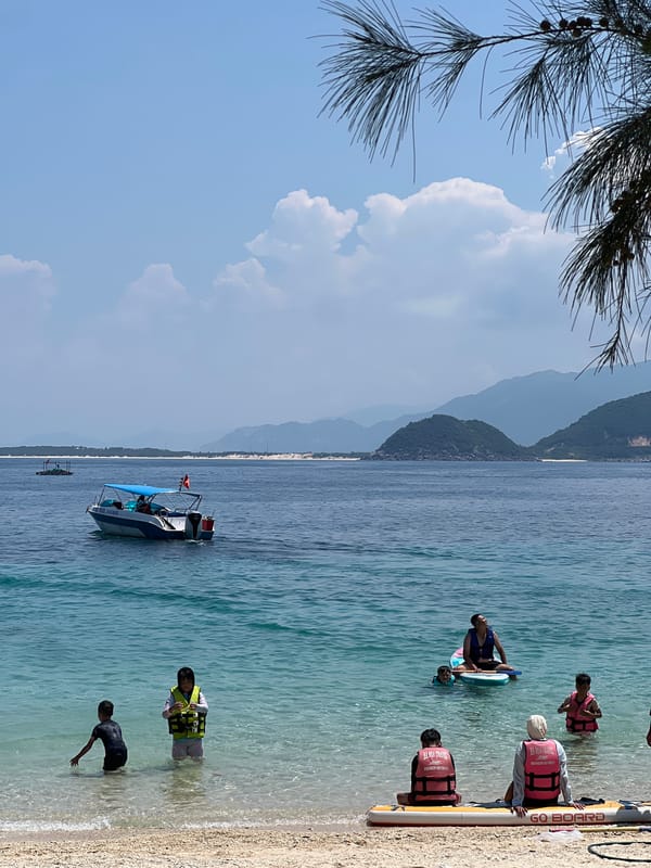 Busy morning at Dai Lanh Beach with swimmers and beach rentals