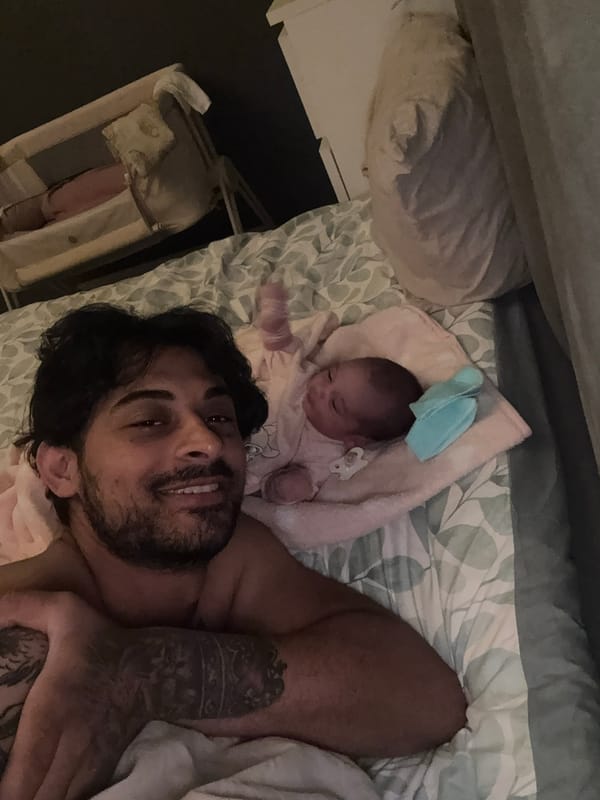 Father and infant share quiet moment in Rotterdam bedroom