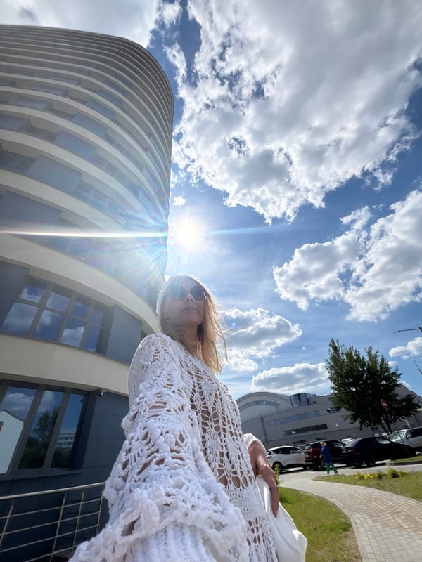 Woman photographed in sunny Minsk street scene with electric car