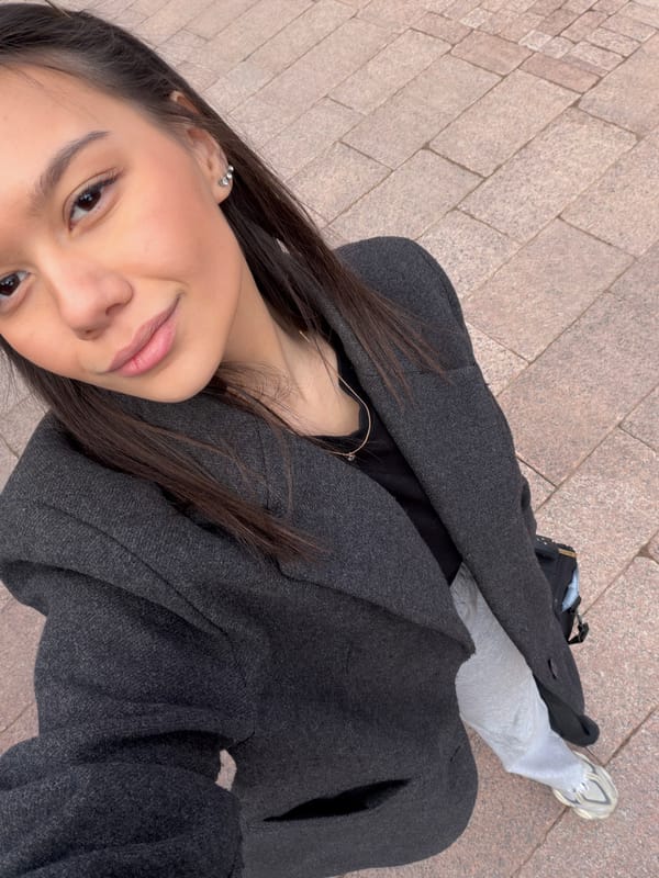 Woman photographed near wooden building in Krasnoyarsk