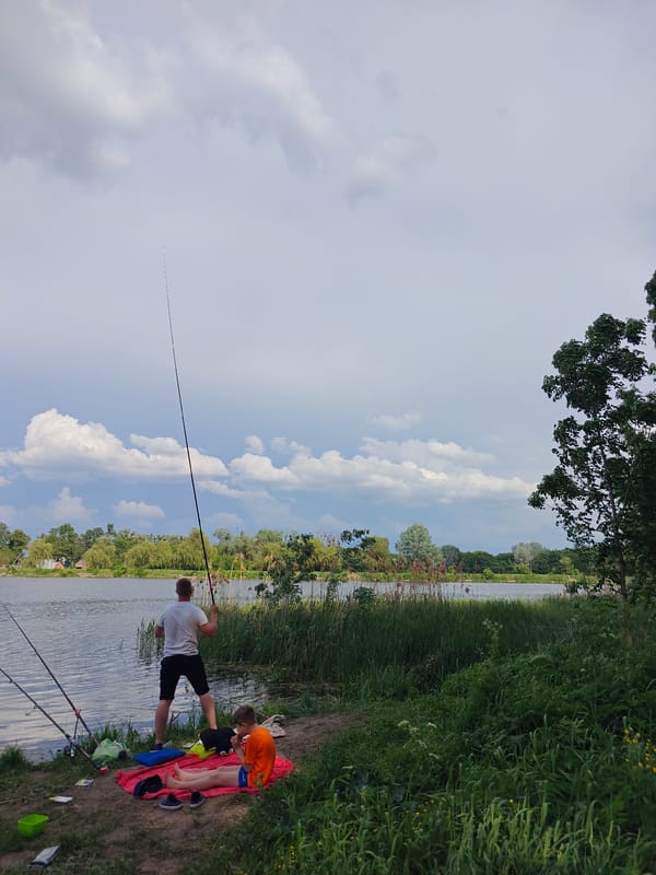 Father and son fishing trip at Ukrainian lake
