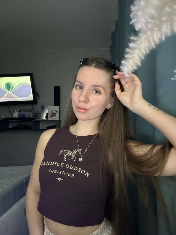 Woman photographs herself indoors during evening in Klin, Russia