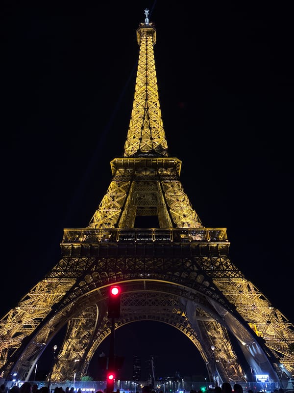 Eiffel Tower glows yellow in evening illumination display