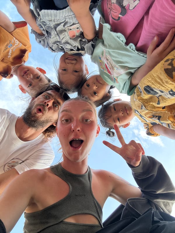 Family group gathers for playful photos in rural Vietnam