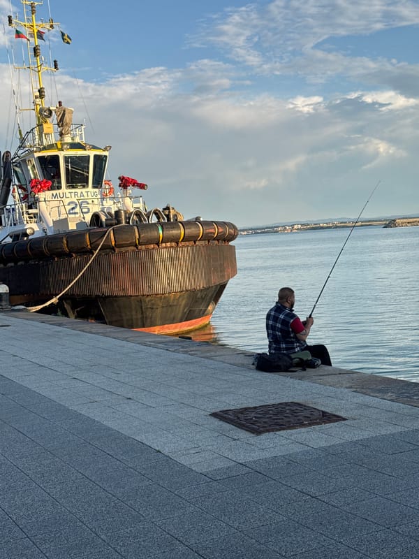 Sunset at Burgas port, tugboats docked and people hanging out dockside
