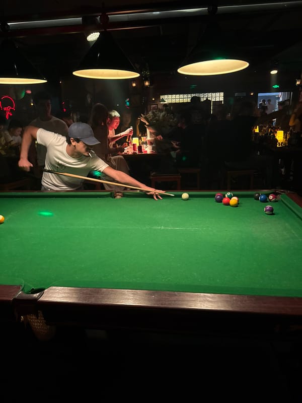 Man plays pool at dimly lit Liangjiang bar