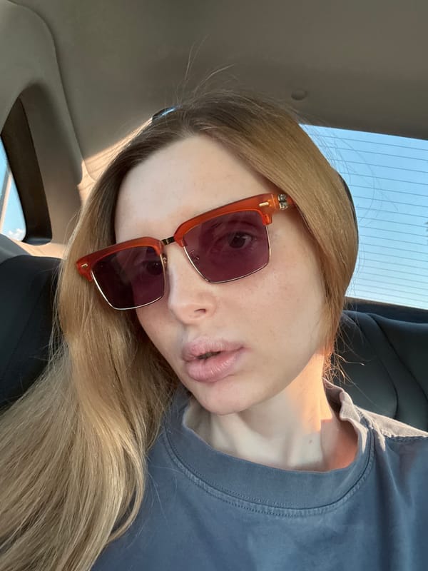 Backseat selfie session with orange sunglasses and striped pants