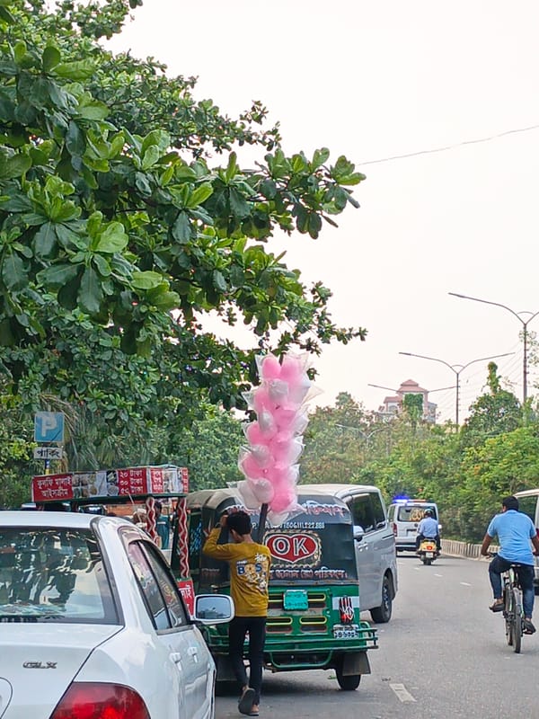Dhaka street scenes show vendors, roadwork, abandoned vehicles