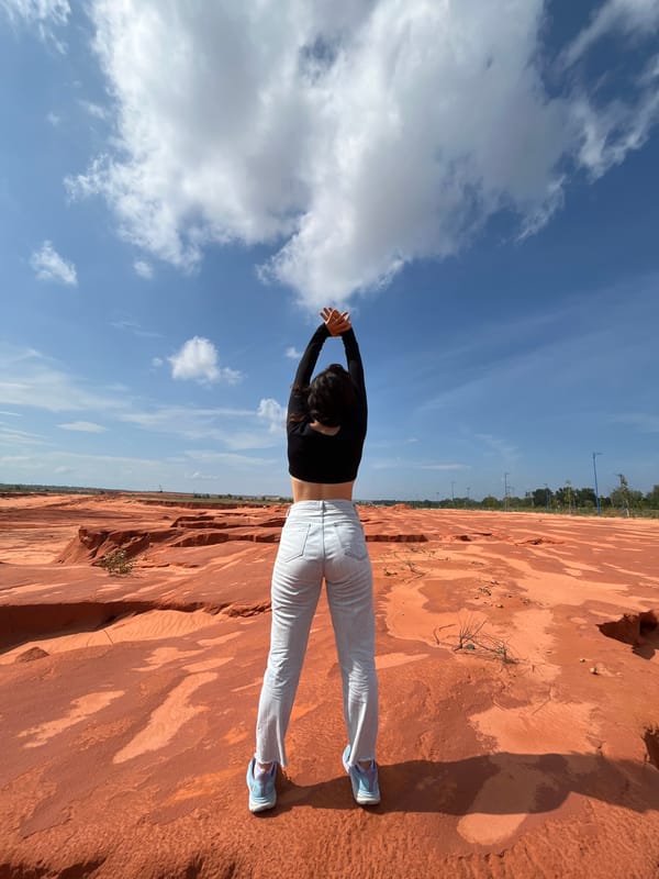 Posing among Mui Ne's orange dunes and red rock formations