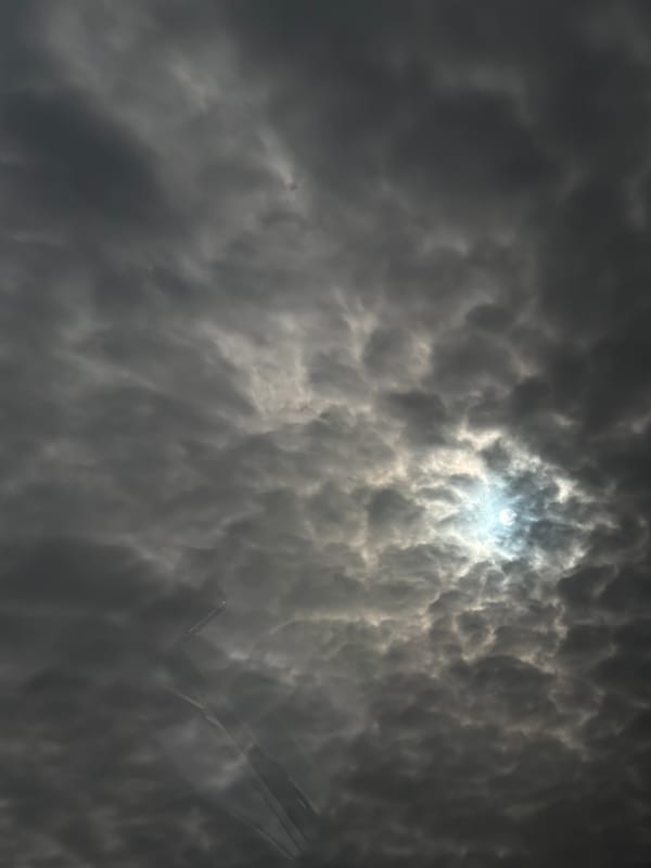 Aircraft spotted through dramatic overcast skies in Jouy-le-Moutier