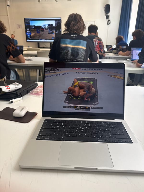 Student watches UFC fight on laptop during Milan classroom session