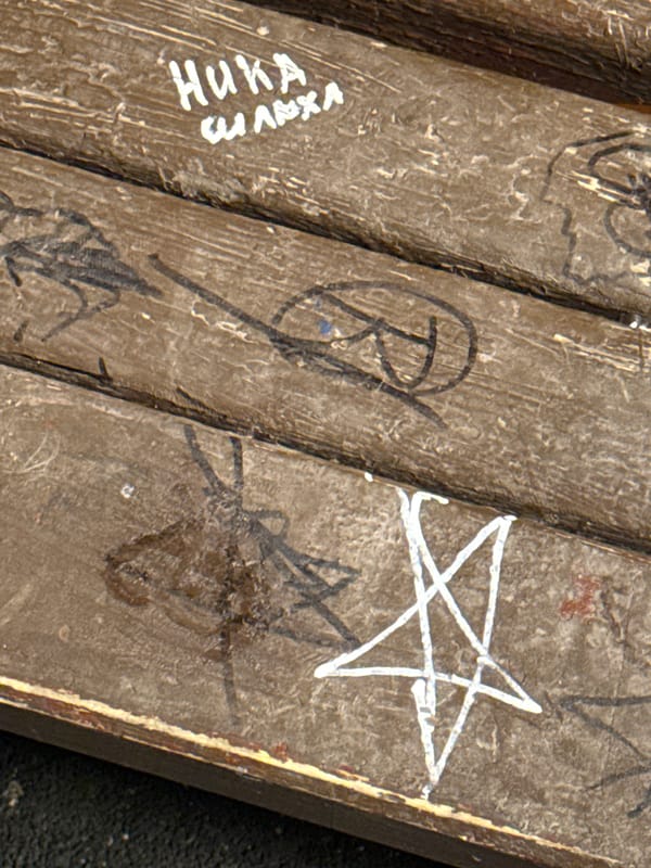 Graffiti-marked wooden planks with Cyrillic script