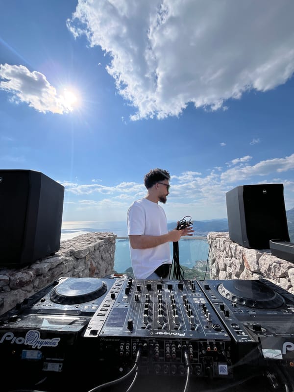 DJ setup documented on Montenegro clifftop overlooking water