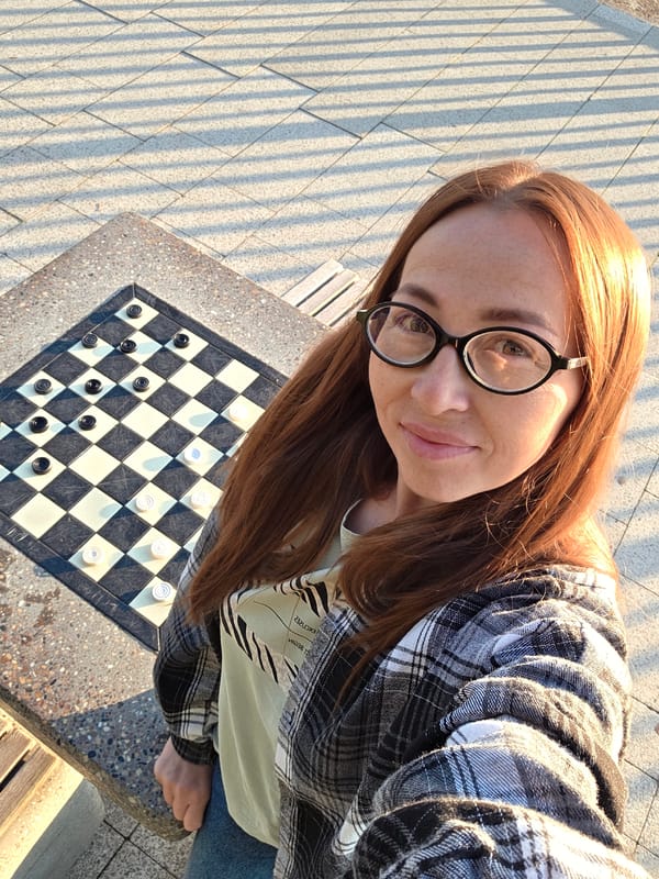 Relaxing at an outdoor checkerboard table in Chaikovsky
