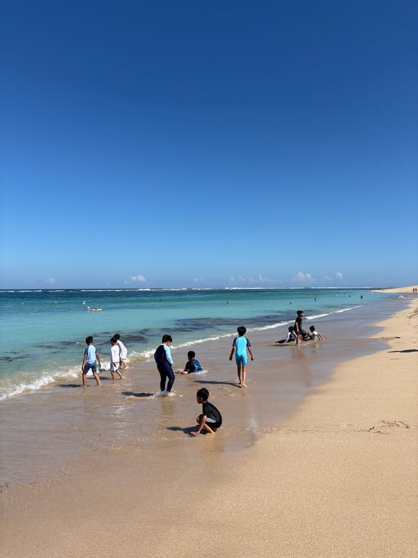 Woman enjoys morning ocean at Nusa Dua beach