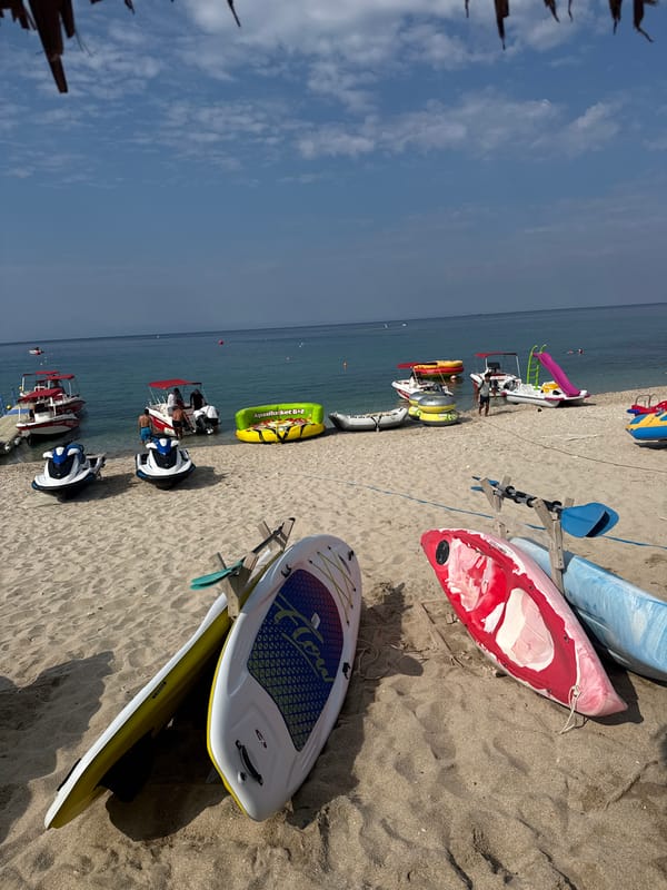 Jet skis on sand and beachwear for sale in Potos, Greece