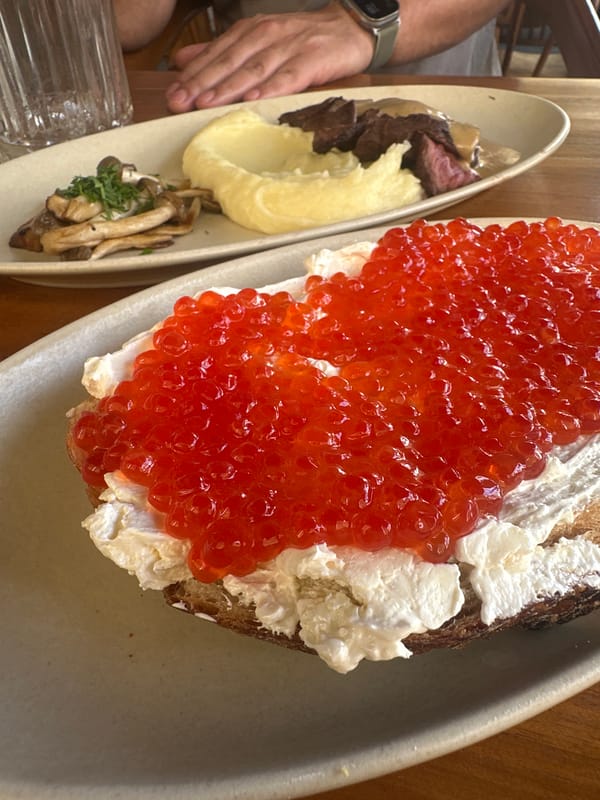 Caviar toast and salmon sushi at a Bali café