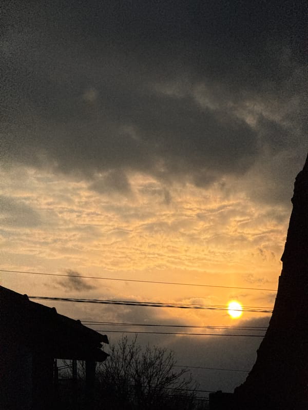 Twilight scene captured in Dobrich, Bulgaria with sun behind clouds