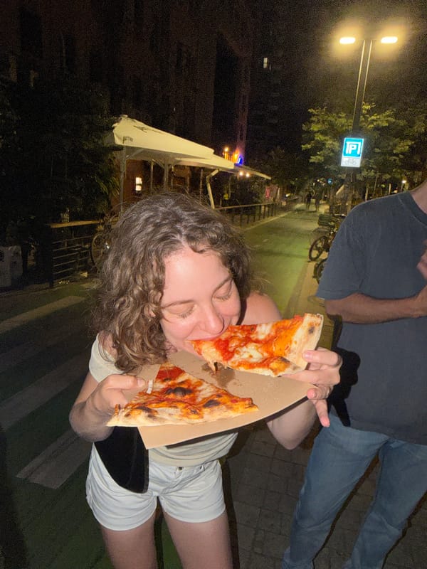 Late-night Tel Aviv street scene: food, wine, and a Yorkie