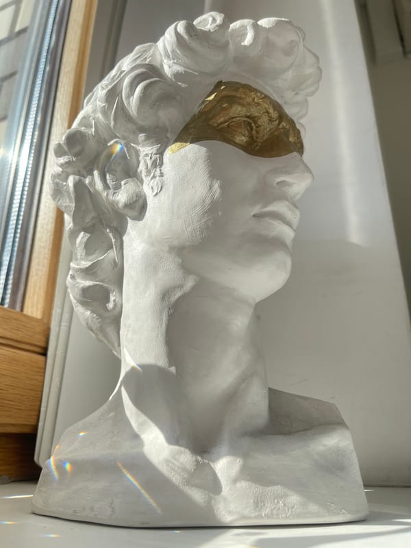 Classical bust, city streets, and a tall ship mast