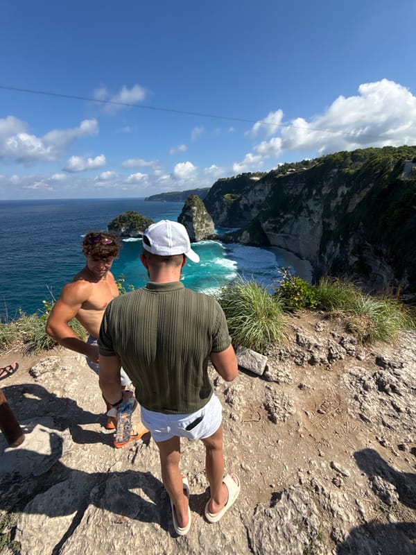 Two men stand on cliff edge in Nusa Penida