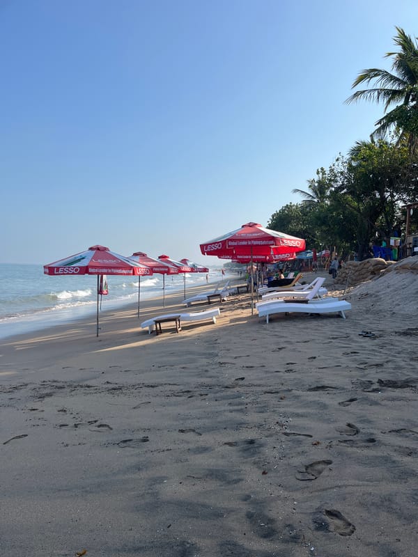 A regular afternoon at Kuta Beach, surfers and sun.