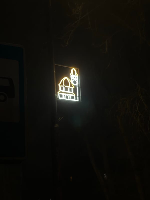 Hotel neon sign glows in Svetlogorsk evening