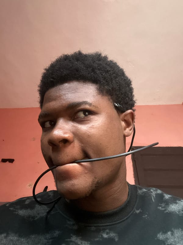 Lazy morning in an Ihiagwa bedroom, cables and earbuds in hand