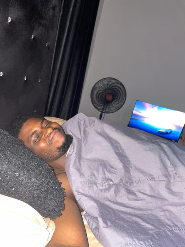 Man resting in bedroom in Akwanga, Nigeria