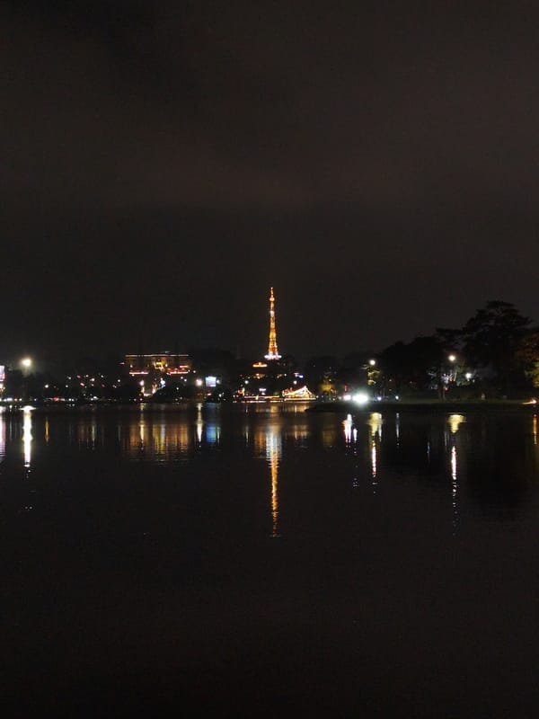 Nighttime lakeside gathering and street performance in Da Lat Vietnam