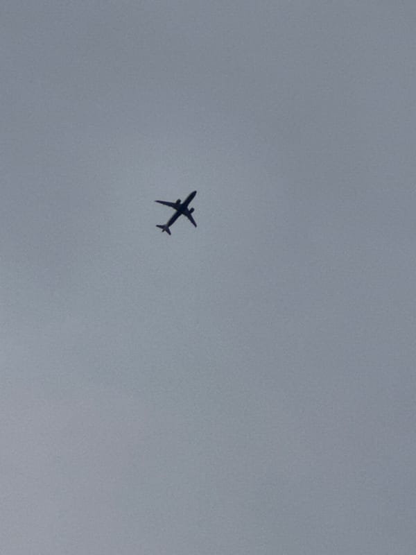 Commercial flight passing overhead, London skies, July evening