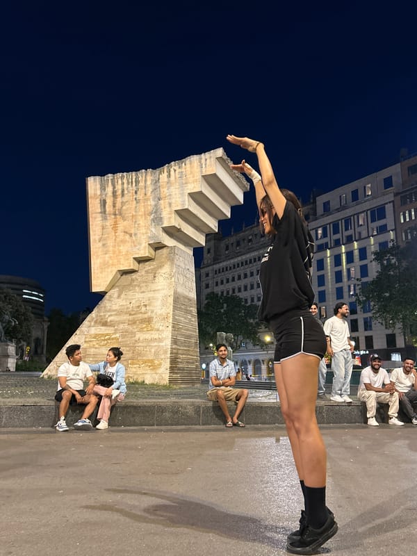 Skateboarder sits by Barcelona fountain during quiet evening