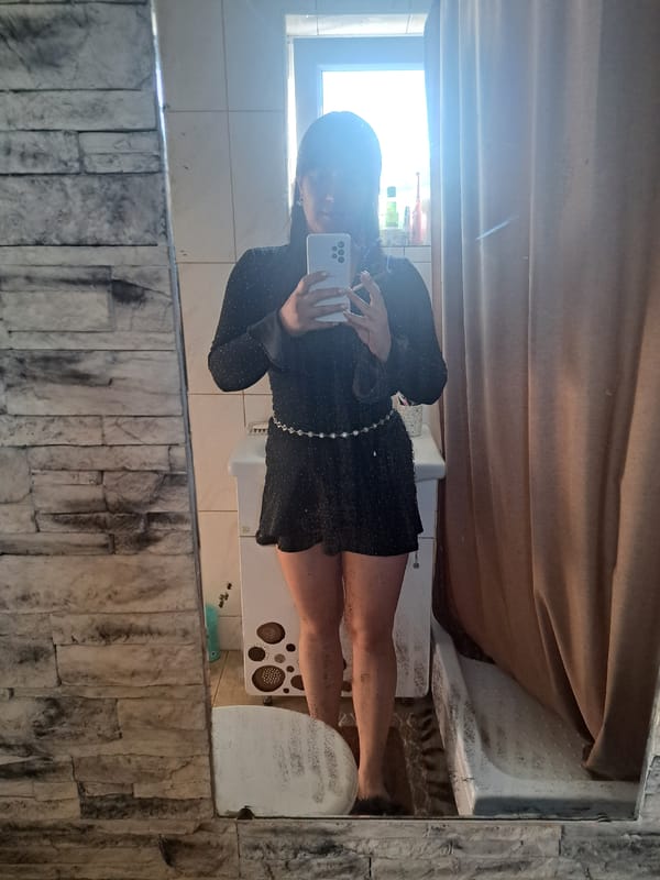 Woman takes bathroom selfies in sparkly dress, Russia