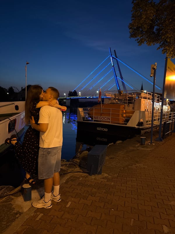 Evening stroll along Mikołajki's waterfront and illuminated suspension bridge