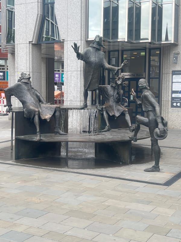 Bronze fountain sculpture with four figures in Bochum