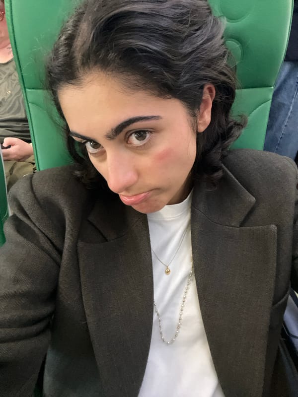 Woman rests on green seat in Sant Josep de sa Talaia
