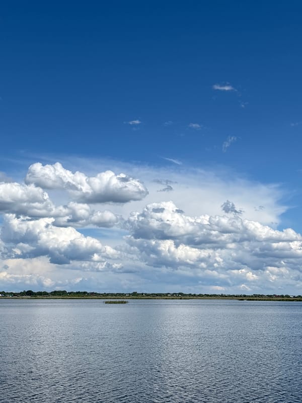 Two people spend quiet moments on dock in Khryashchevka