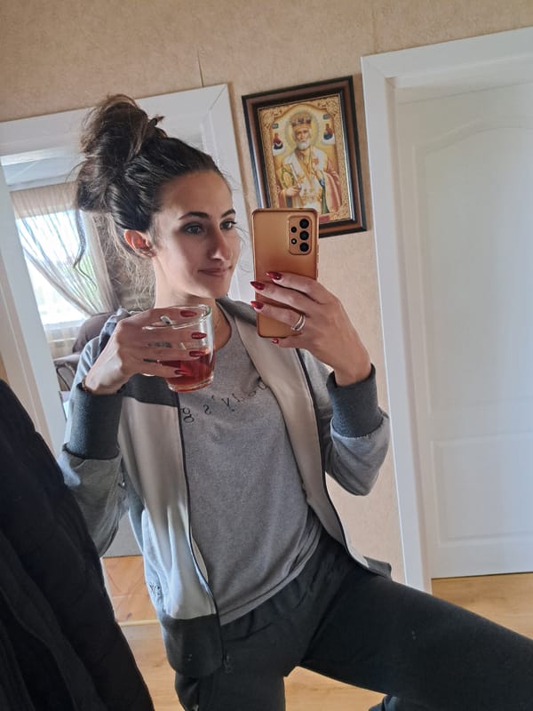Woman takes playful selfies indoors in Bulgarian village