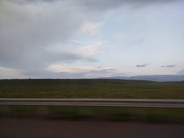Overcast skies with colorful clouds observed over Armenian grasslands