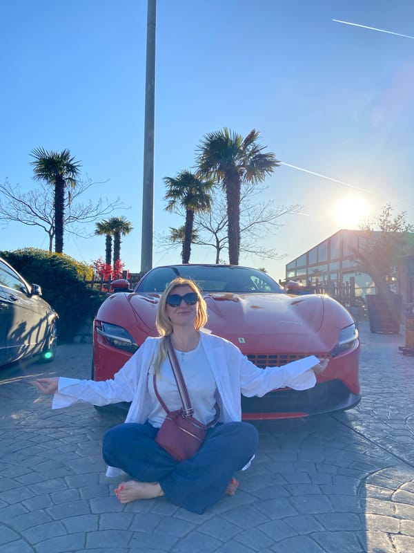 Woman poses with red Ferrari in Montenegro villages