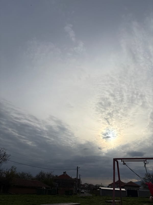 Playground and rural landscape observed under cloudy afternoon skies