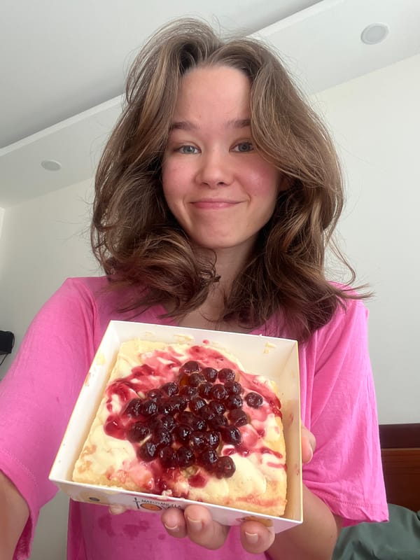 Woman holds pastry dessert at Vietnam heritage site