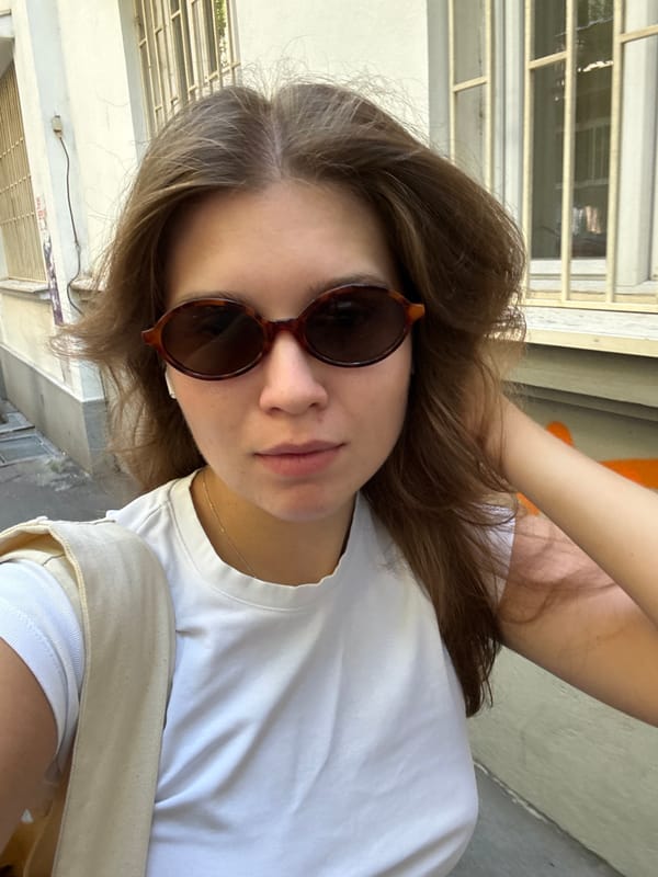 Woman takes selfie in graffitied Belgrade alleyway