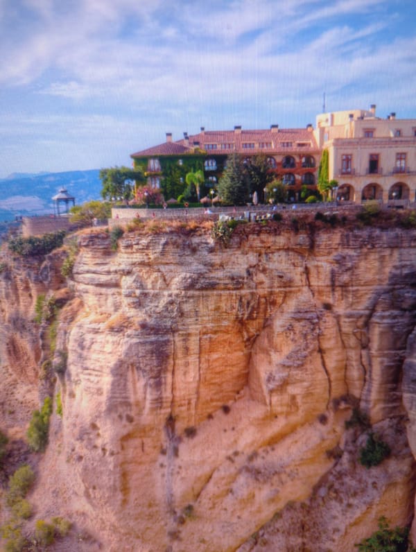 Historic stone building clings to cliff edge in Altai, Kazakhstan