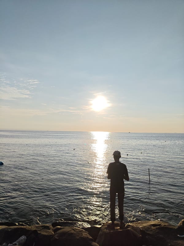 Sunset fishing scene captured along Lhokseumawe coastline