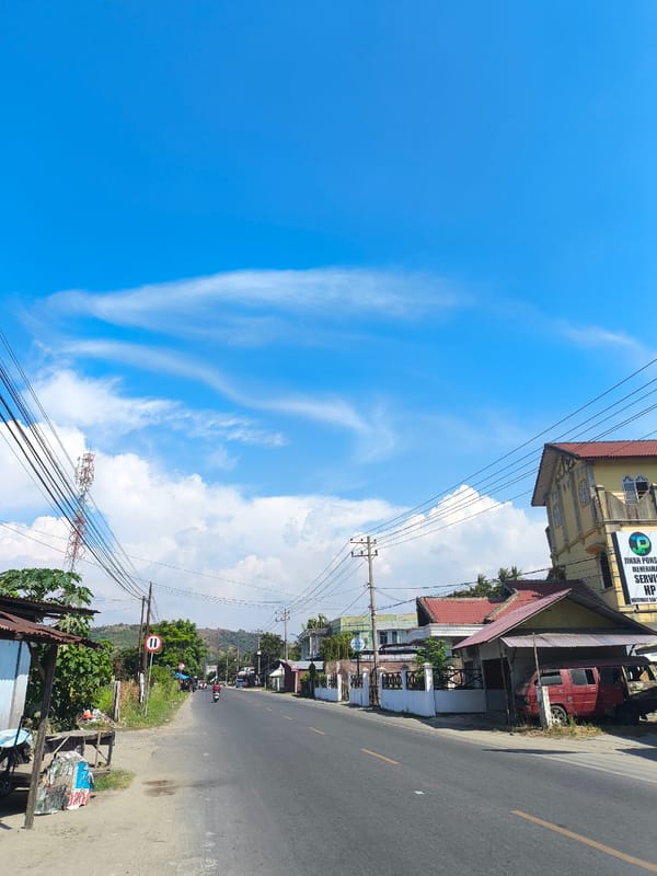 Clear morning on a quiet paved road in Juliseutuy, Indonesia