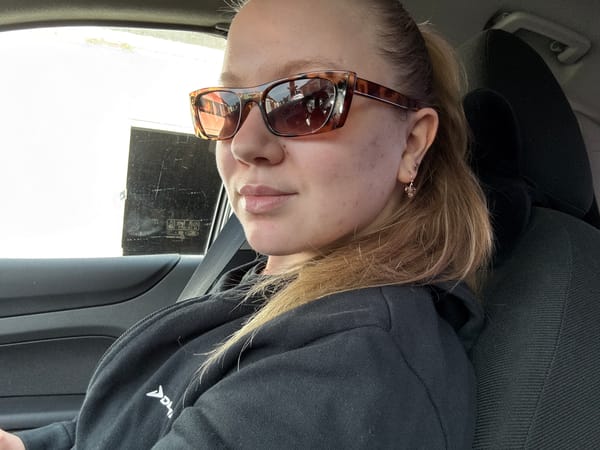 Selfie in a car, Chaikovsky — tortoiseshell shades and flower earring
